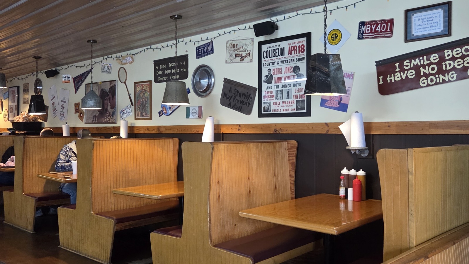 Wooden booths and decorated wall inside JD's Smokehouse