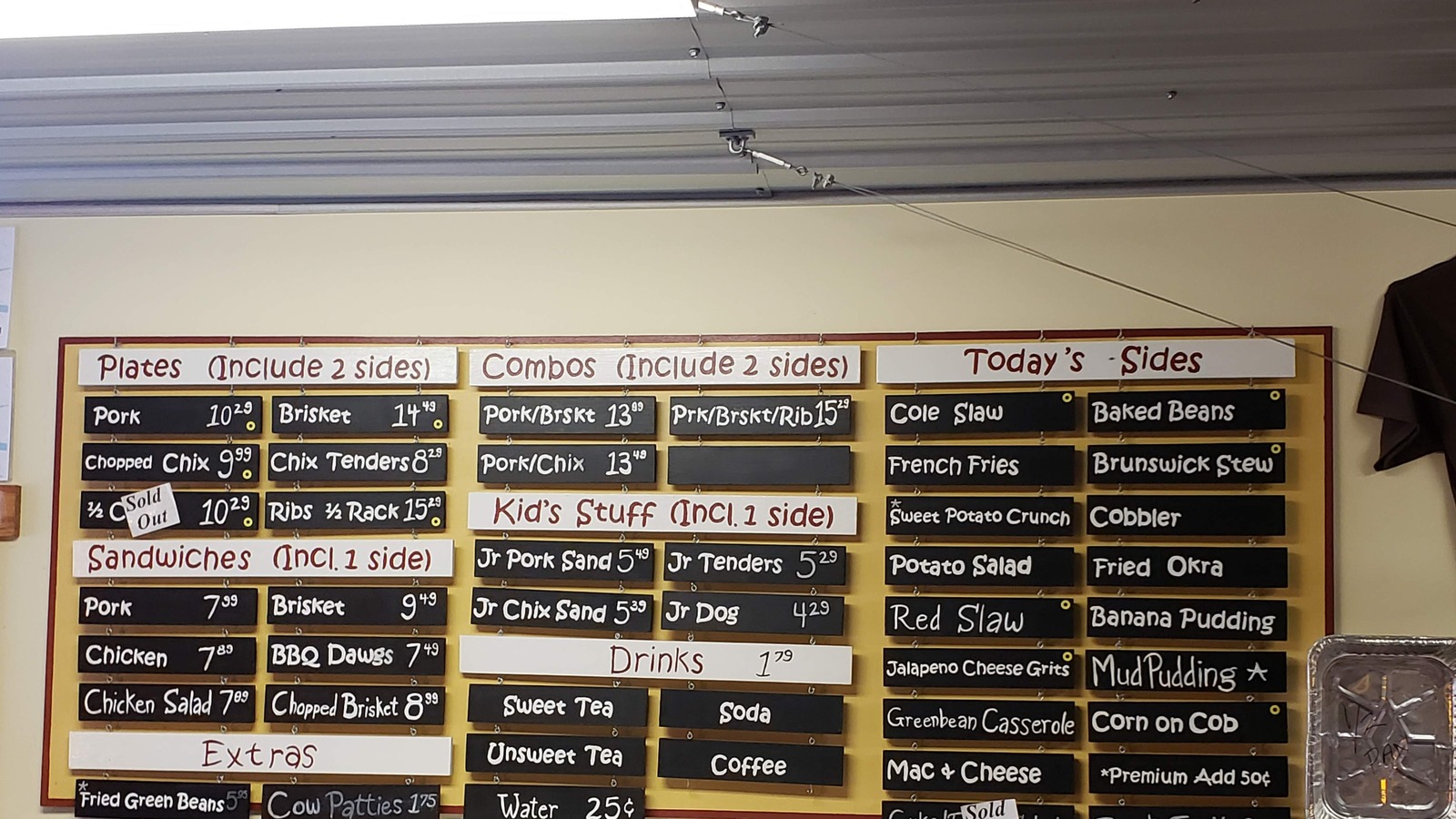 JD's Smokehouse handwritten menu board with plates, combos, sandwiches, and sides