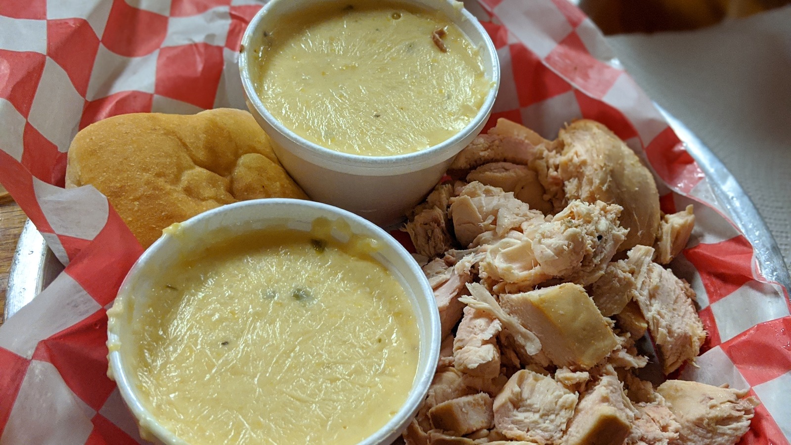 Chicken plate with jalapeño cheese grits and bread at JD's Smokehouse