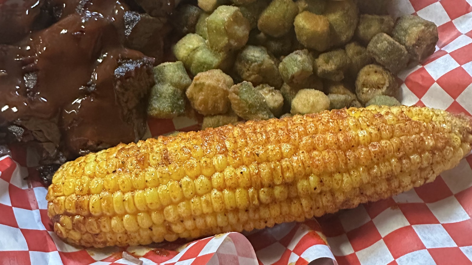 Brisket plate with fried okra, corn on the cob, and bread at JD's Smokehouse
