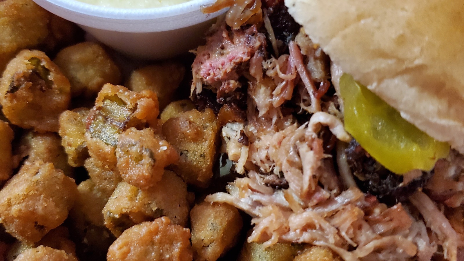 Pulled pork sandwich with fried okra and cheese grits at JD's Smokehouse