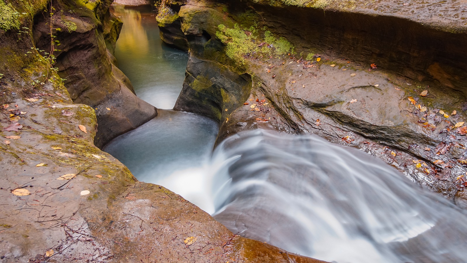 Water rushing through a smooth sandstone chute in Hocking Hills State Park