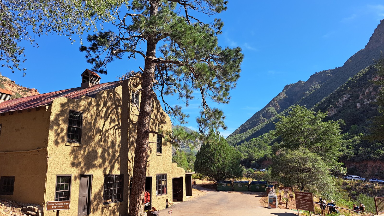 The main paved path near the market building with canyon walls rising above Slide Rock State Park