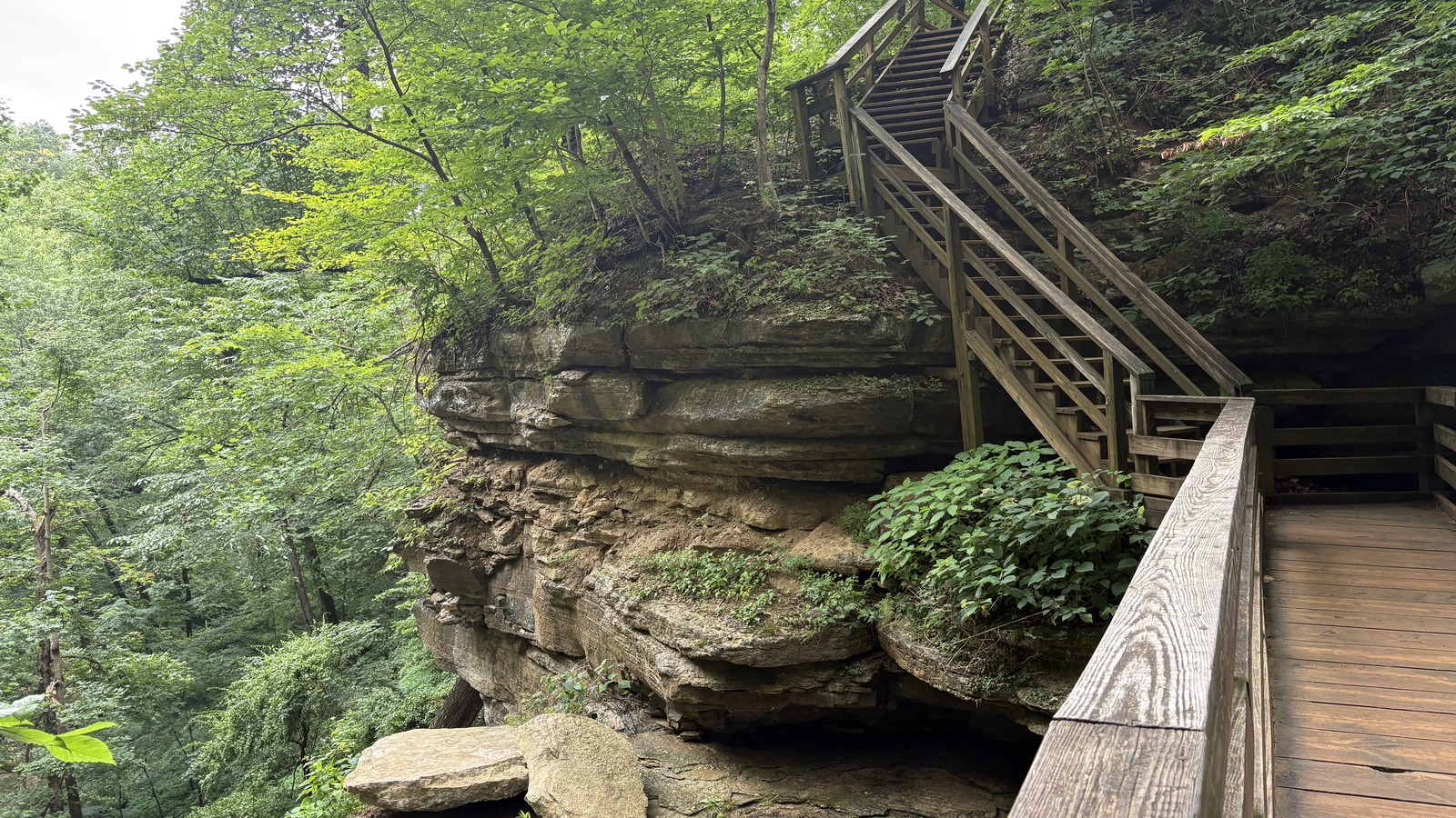 Boardwalk and stairway threading through the stone-walled canyon at Clifty Falls State Park.
