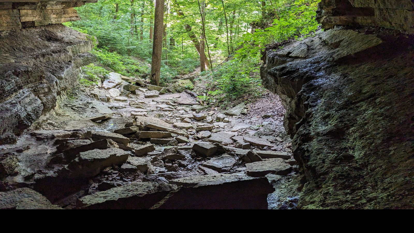 Rocky passage beneath a deep sandstone overhang at Clifty Falls State Park.