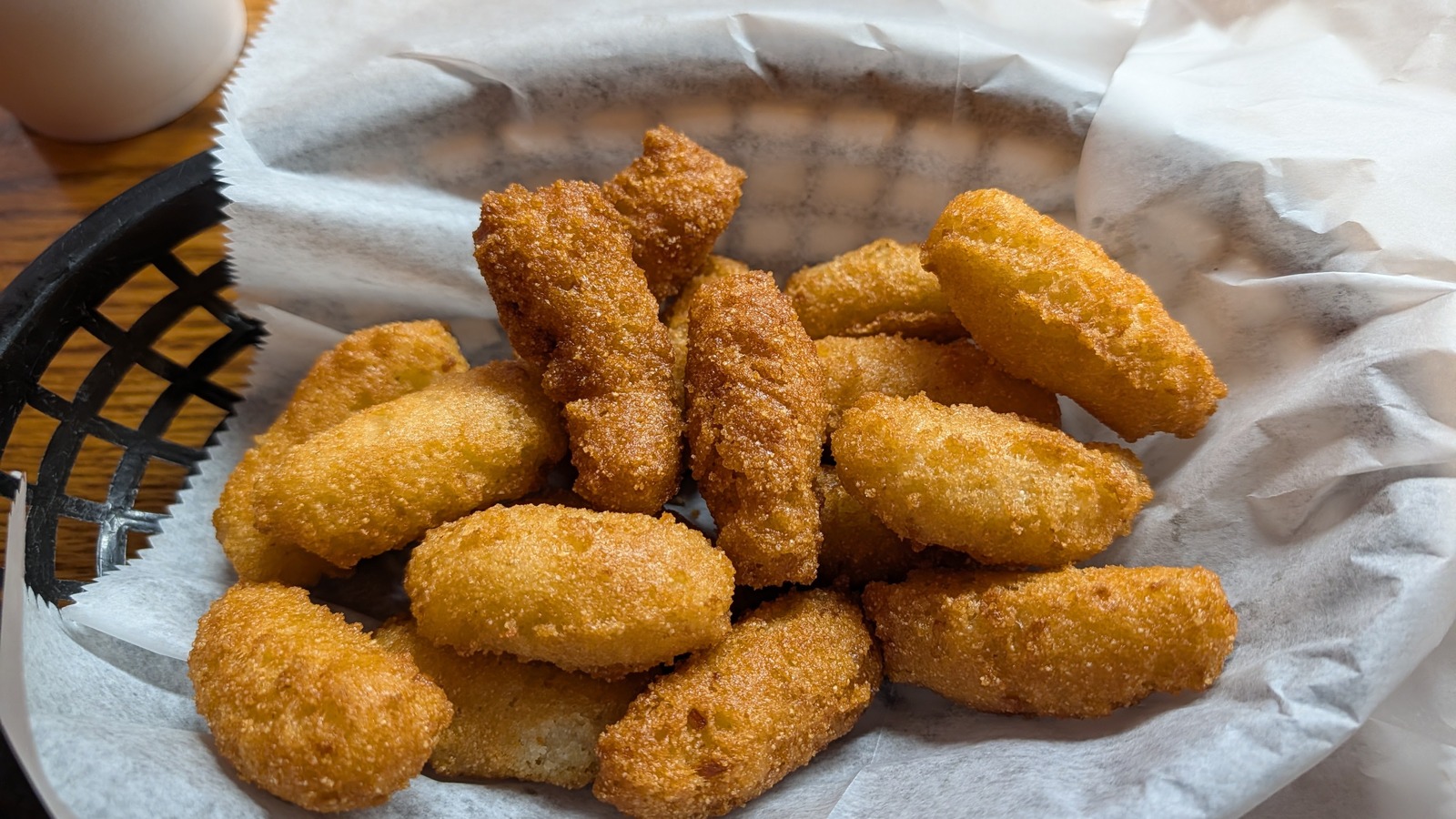 Basket of golden hush puppies at Lexington Barbecue