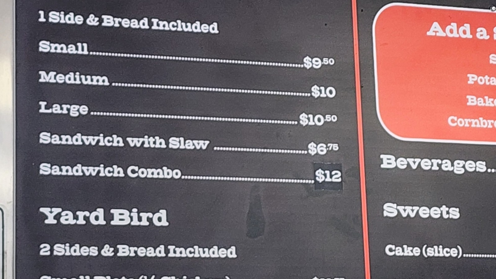 Menu board and counter area at Skylight Inn BBQ with stacked cups and serving station