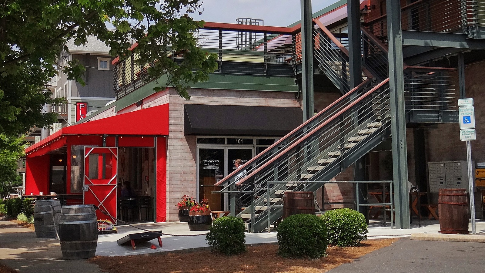 Midwood Smokehouse facade on Central Avenue with its red awning and upper deck.