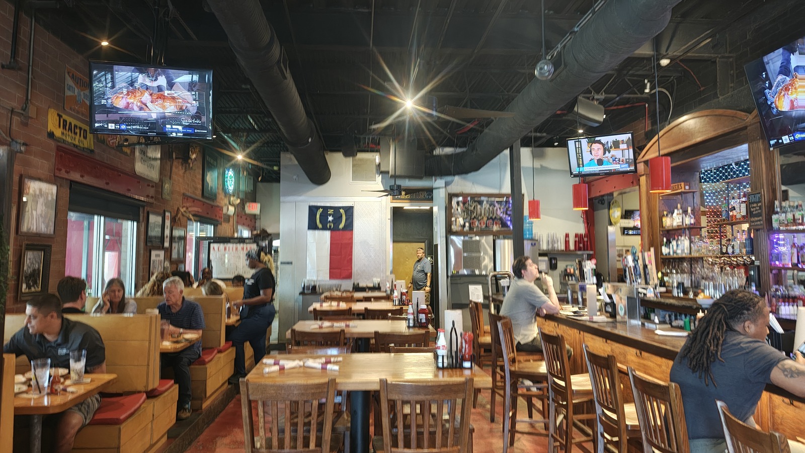 Wood booths and the bar area inside Midwood Smokehouse in Plaza Midwood.