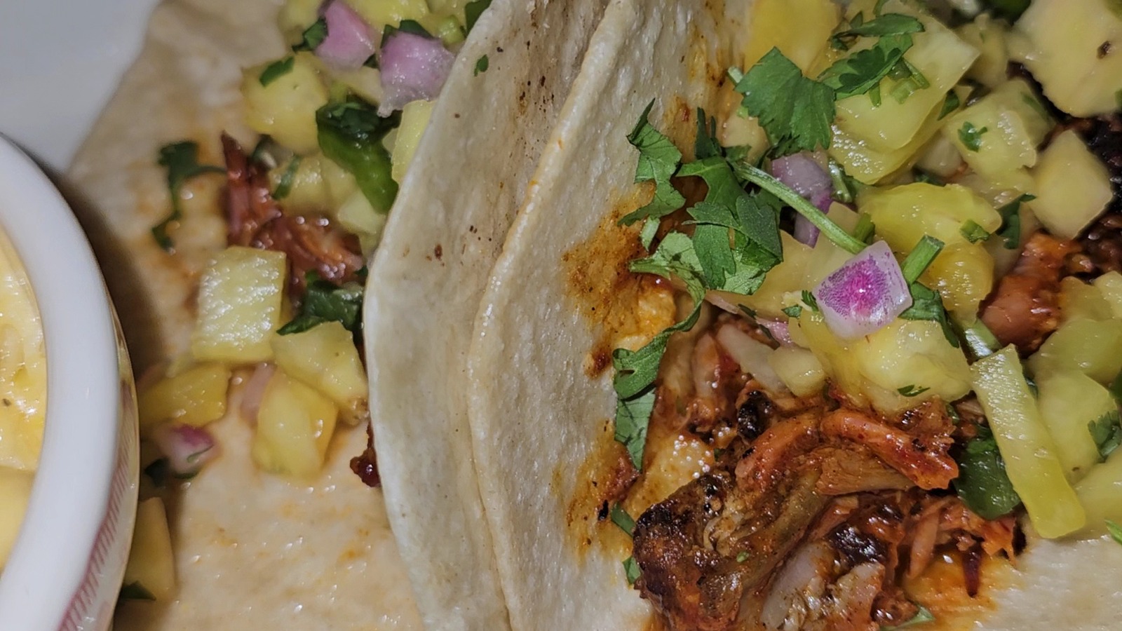 Smoked meat tacos topped with pineapple salsa at Midwood Smokehouse.