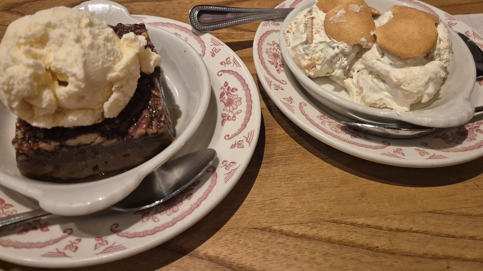 Pecan cobbler and banana pudding on a wooden table at Midwood Smokehouse.