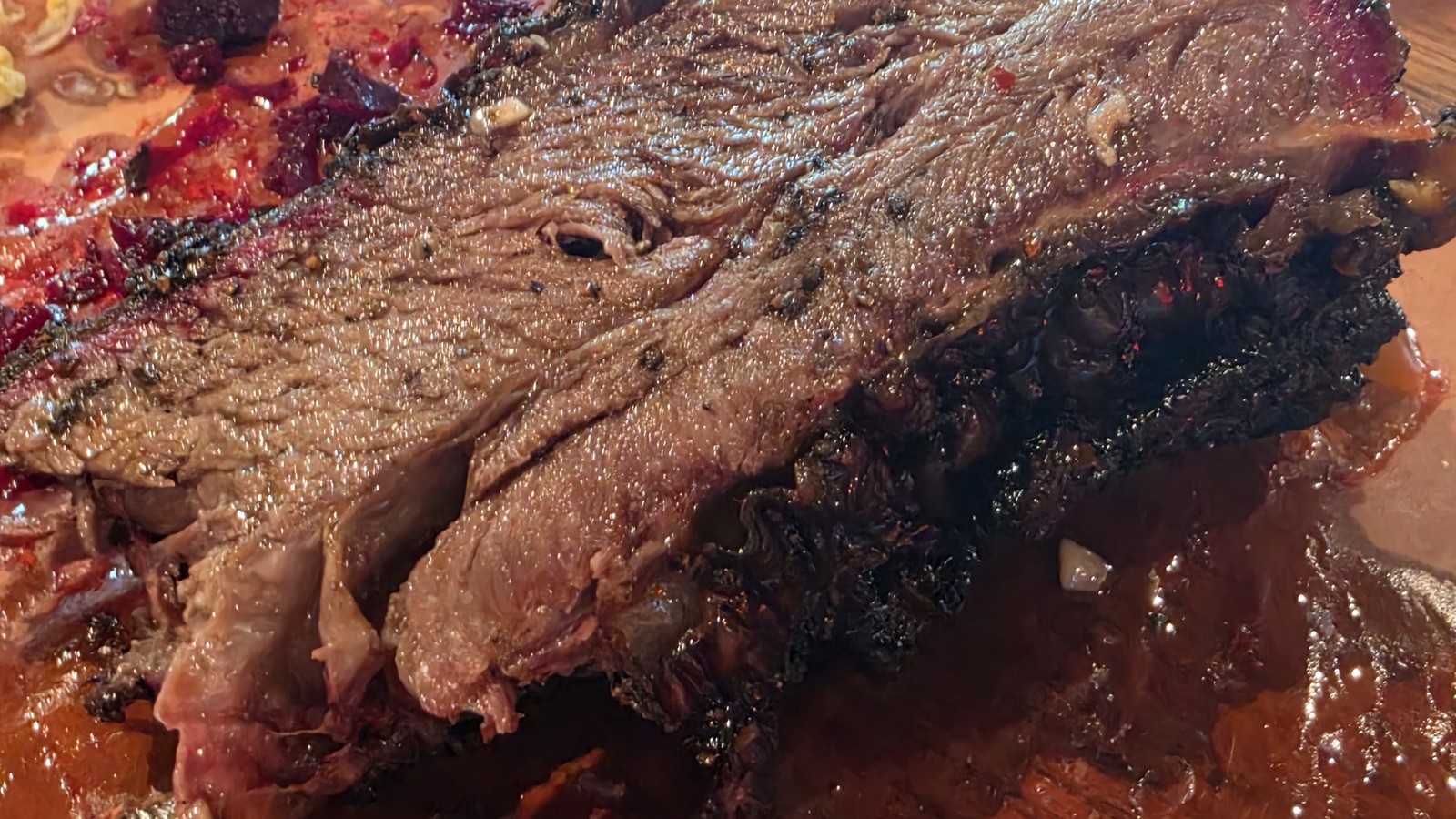 Close view of a beef rib with peppery bark at ZZQ Texas Craft Barbeque