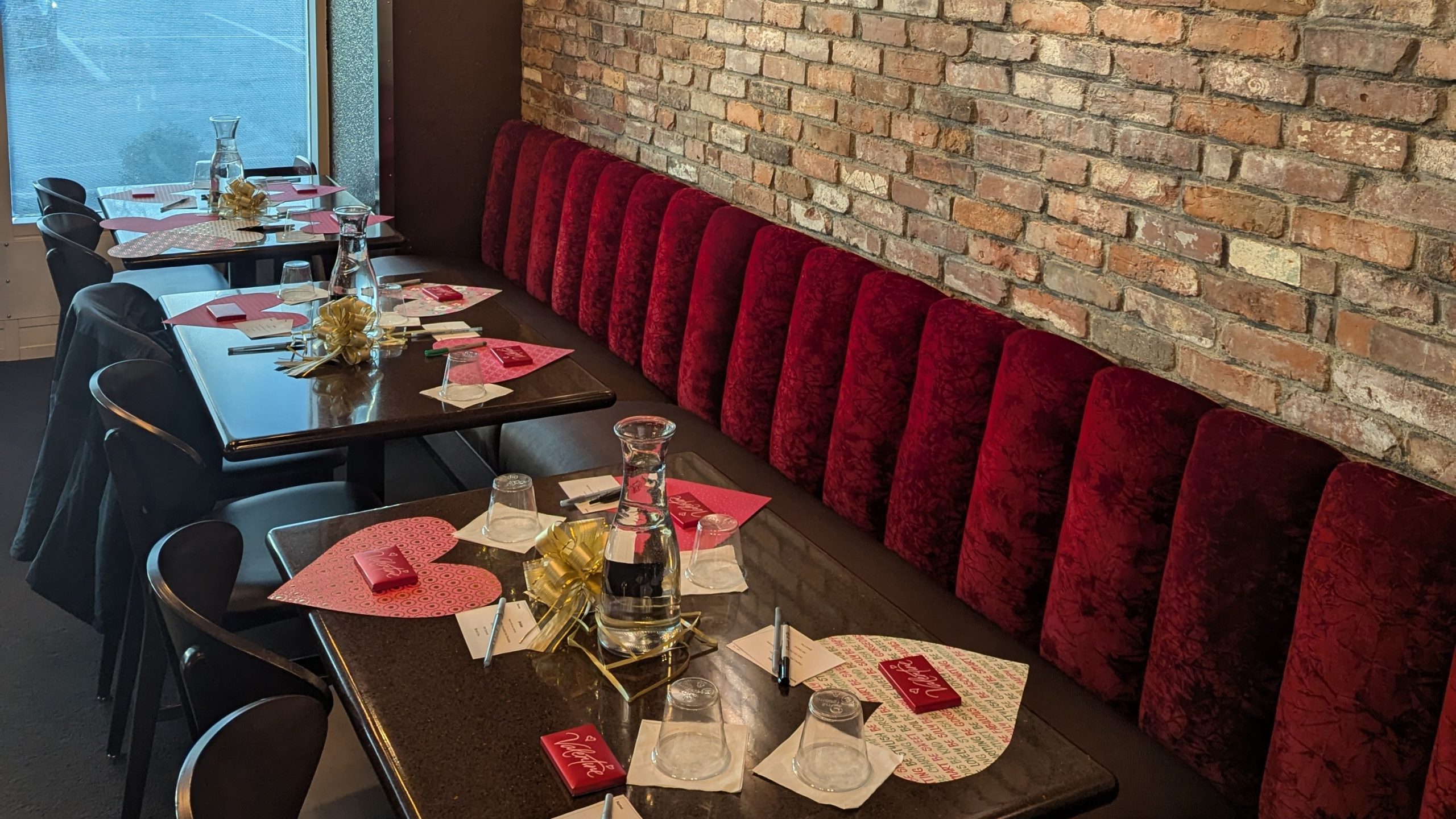 Brick wall banquet seating arranged for a private gathering at DeBrand Fine Chocolates