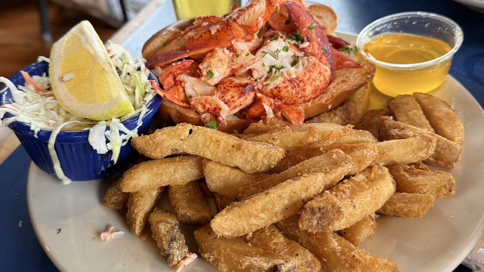 lobster roll with fries, slaw, butter, and a pint at Boston Sail Loft