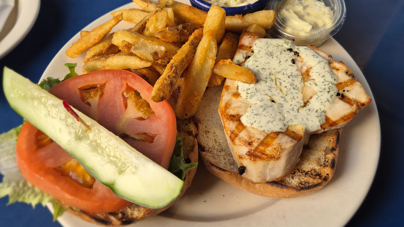 grilled fish sandwich with fries and slaw at Boston Sail Loft