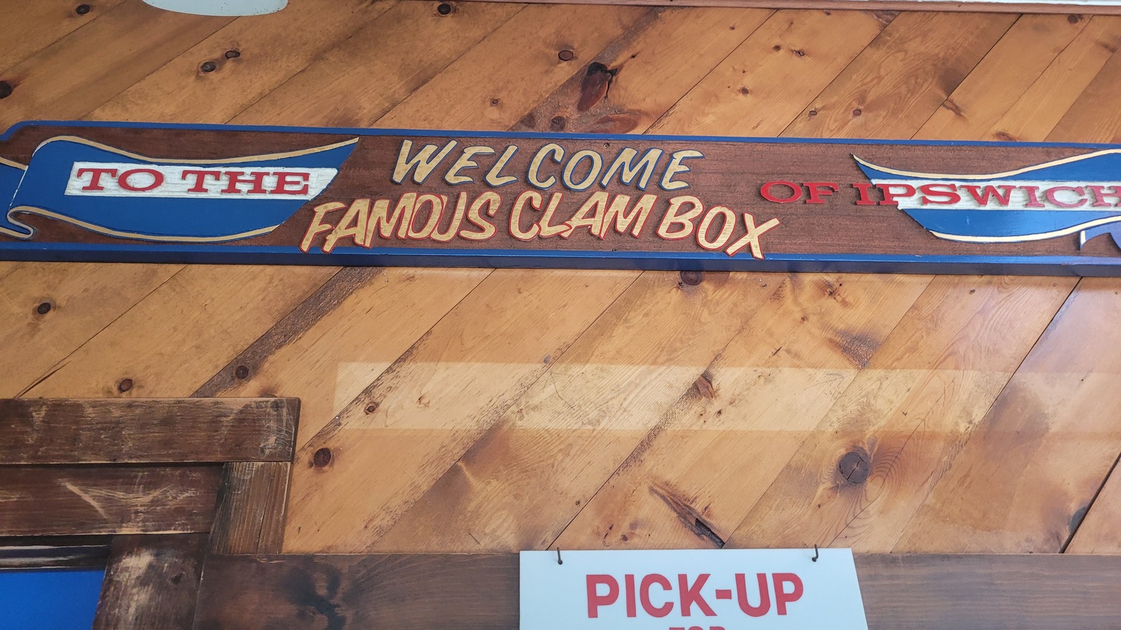 Painted welcome sign for the famous Clam Box mounted above the pickup window.