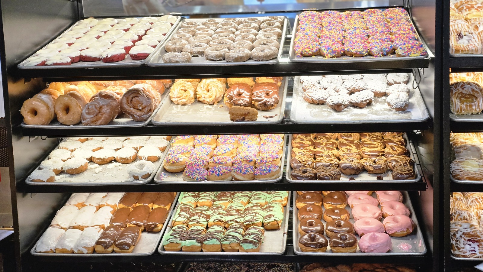 Stacked trays of doughnuts and pastries inside Weber's Bakery
