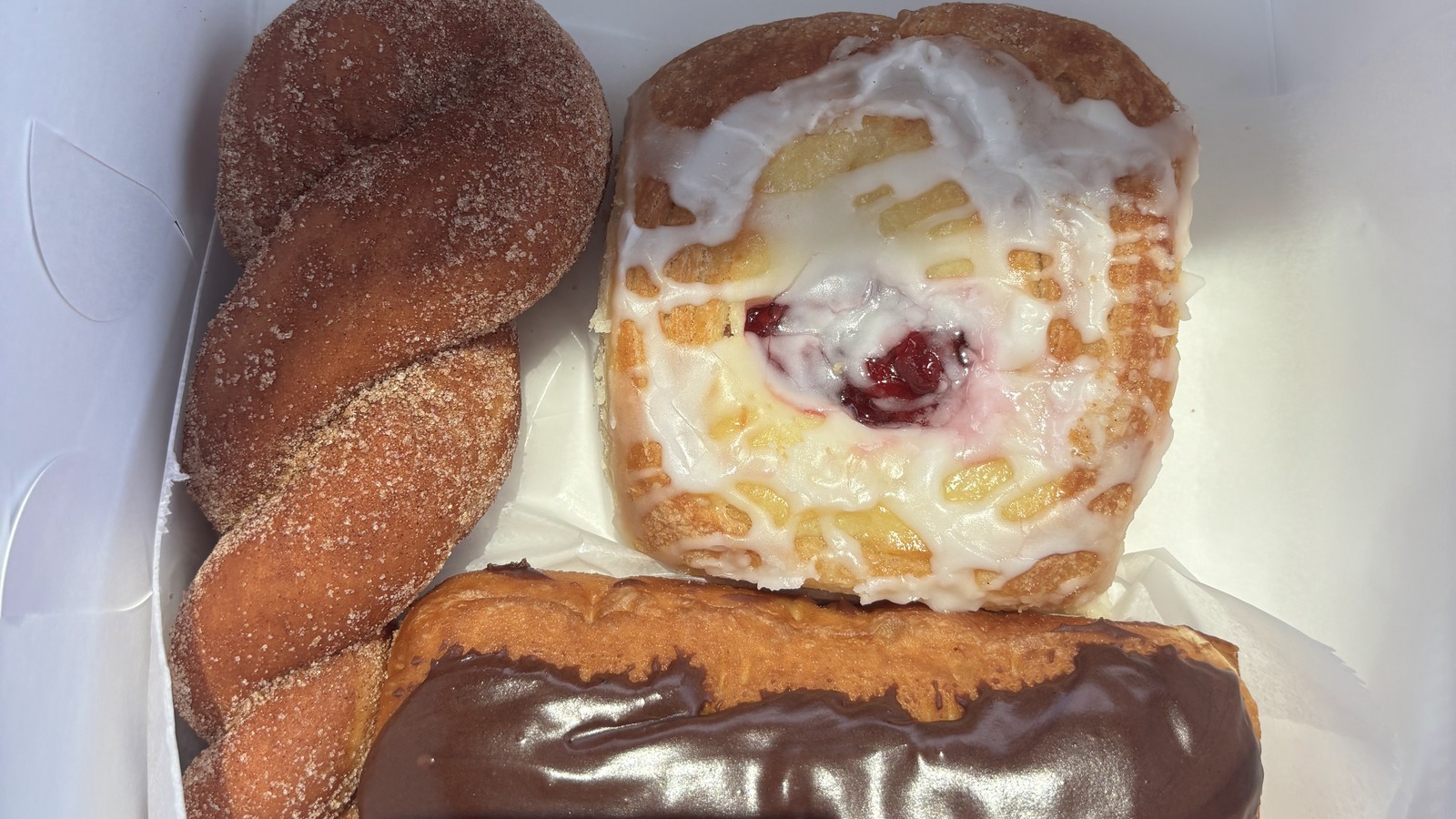 Pastry box with twist, cheese pastry, and chocolate eclair from Weber's Bakery