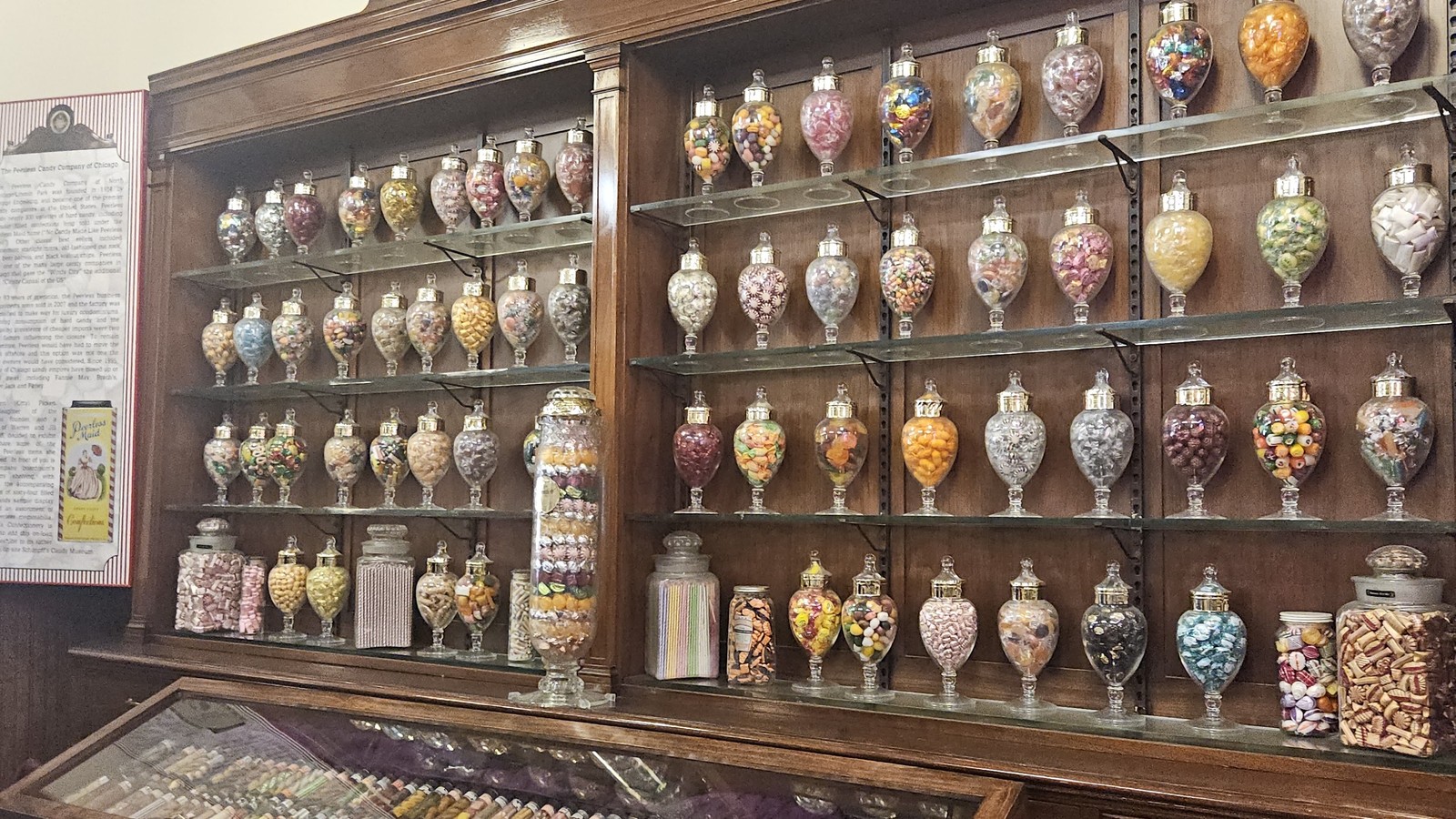 Wall of apothecary jars filled with colorful candy inside Schimpff's Confectionery