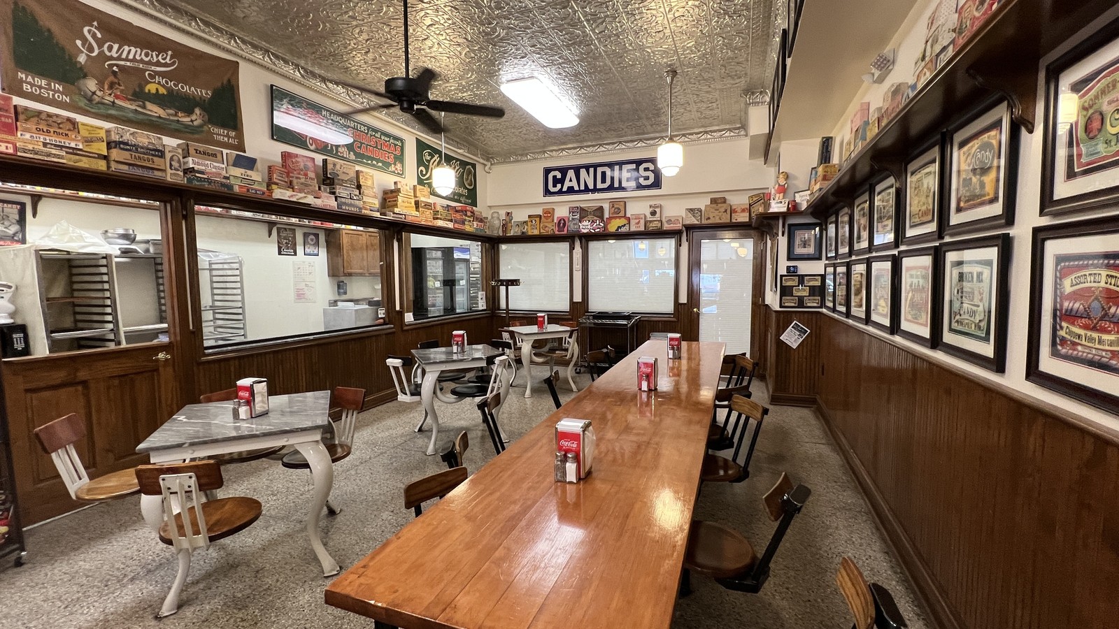Marble-top tables and candy kitchen windows inside the Schimpff's soda fountain