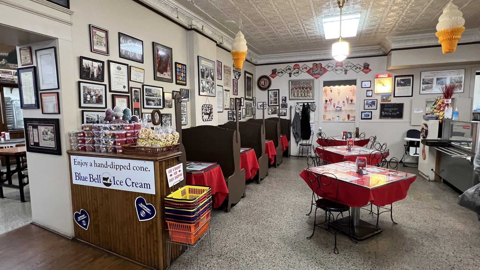 Red tables, wall photos, and soda fountain seating inside Schimpff's Confectionery