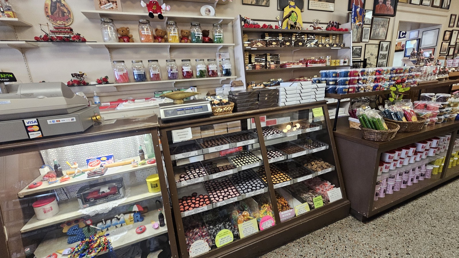 Candy counter lined with jars, shelves, and boxed sweets inside Schimpff's Confectionery