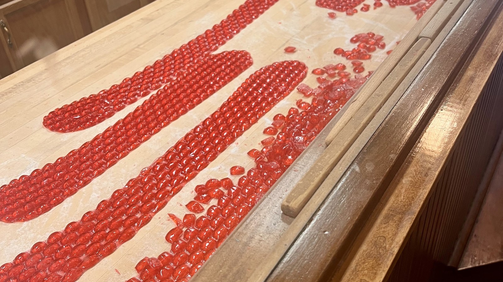Fresh cinnamon red hots cooling on the demonstration table at Schimpff's Confectionery
