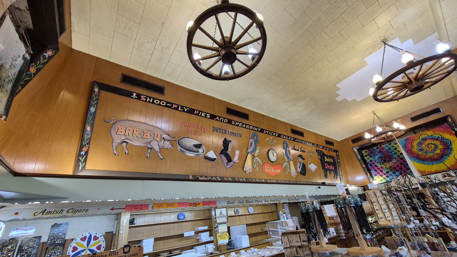Dutch Haven counter area with wagon-wheel lights and painted wall mural.