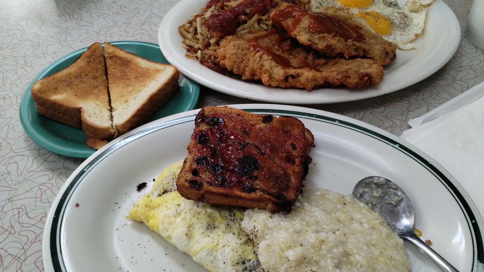 Country ham over grits with toast and eggs on a breakfast plate at Silver Skillet
