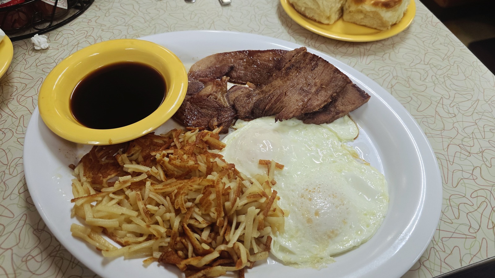 Steak, eggs, hashbrowns, and red-eye gravy on a breakfast plate at Silver Skillet
