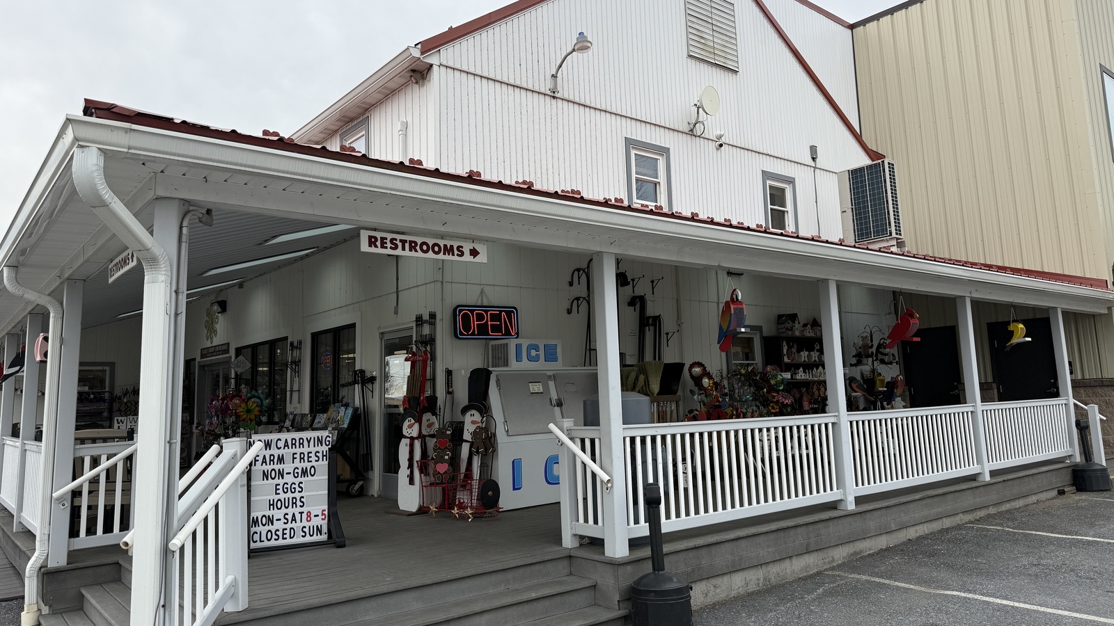 White porch, open sign, and main entrance at Bird-in-Hand Bake Shop