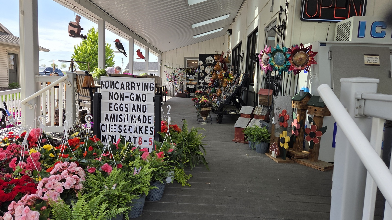 Porch flowers, local gift displays, and farm-fresh eggs sign at Bird-in-Hand Bake Shop