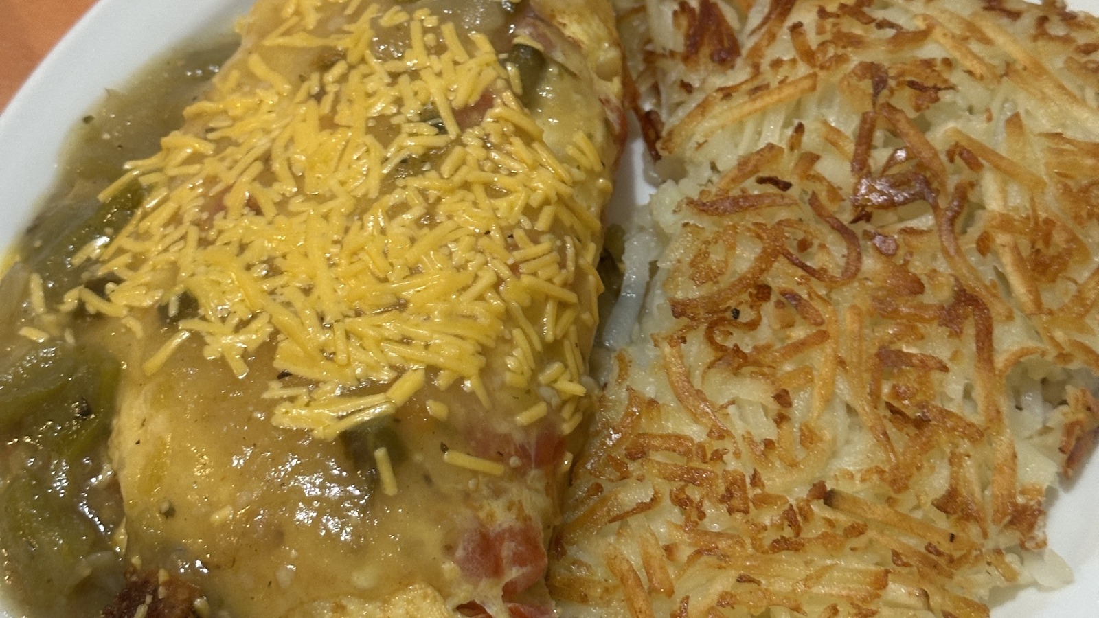Green chile omelette with melted cheese and hash browns at Original Breakfast House