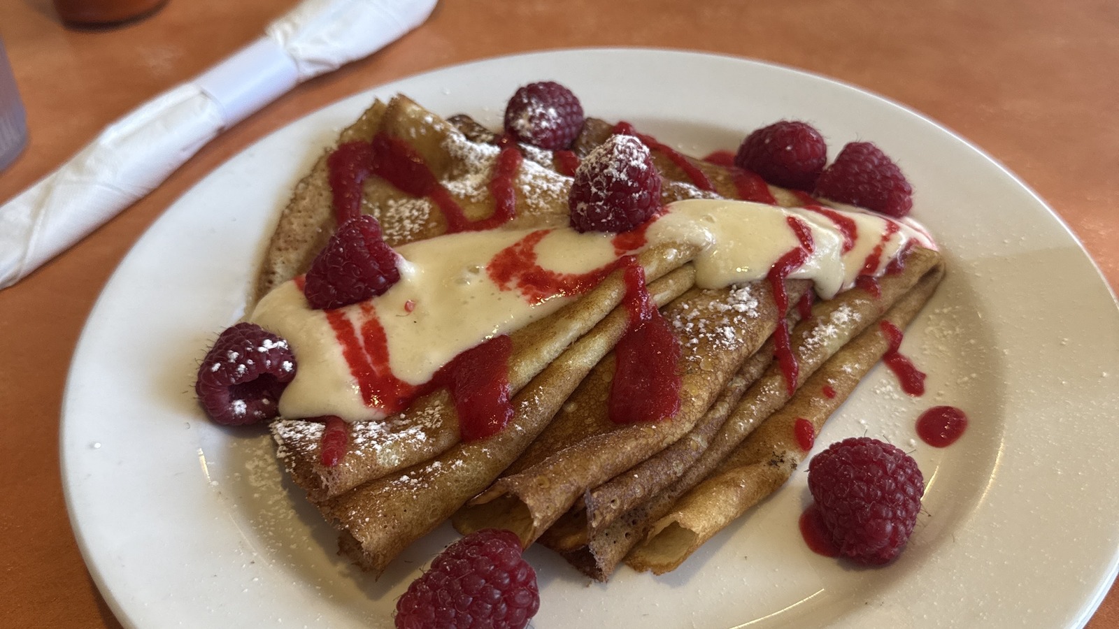 Raspberry crepes topped with powdered sugar at Original Breakfast House