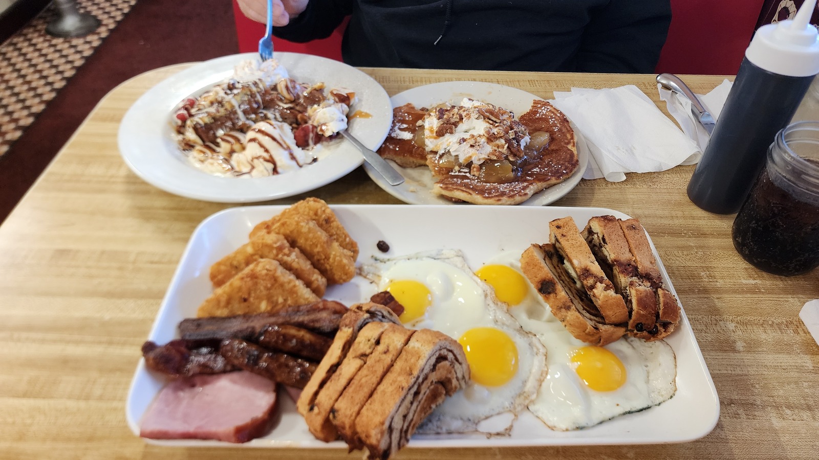 Large breakfast spread with eggs, meats, hash browns, and sweet plates at Miss Worcester Diner