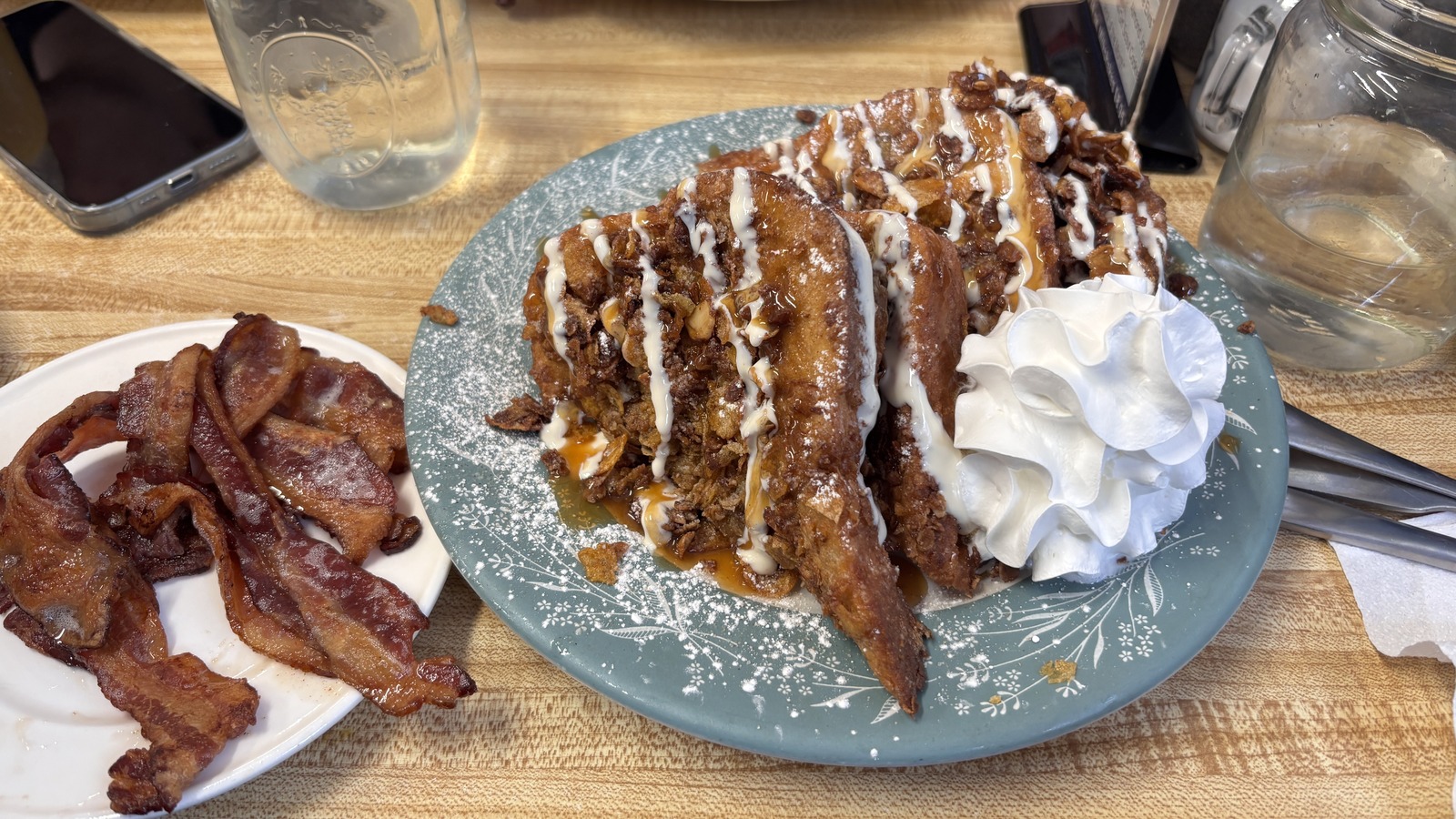 Loaded French toast topped with whipped cream and crunchy sweet layers at Miss Worcester Diner