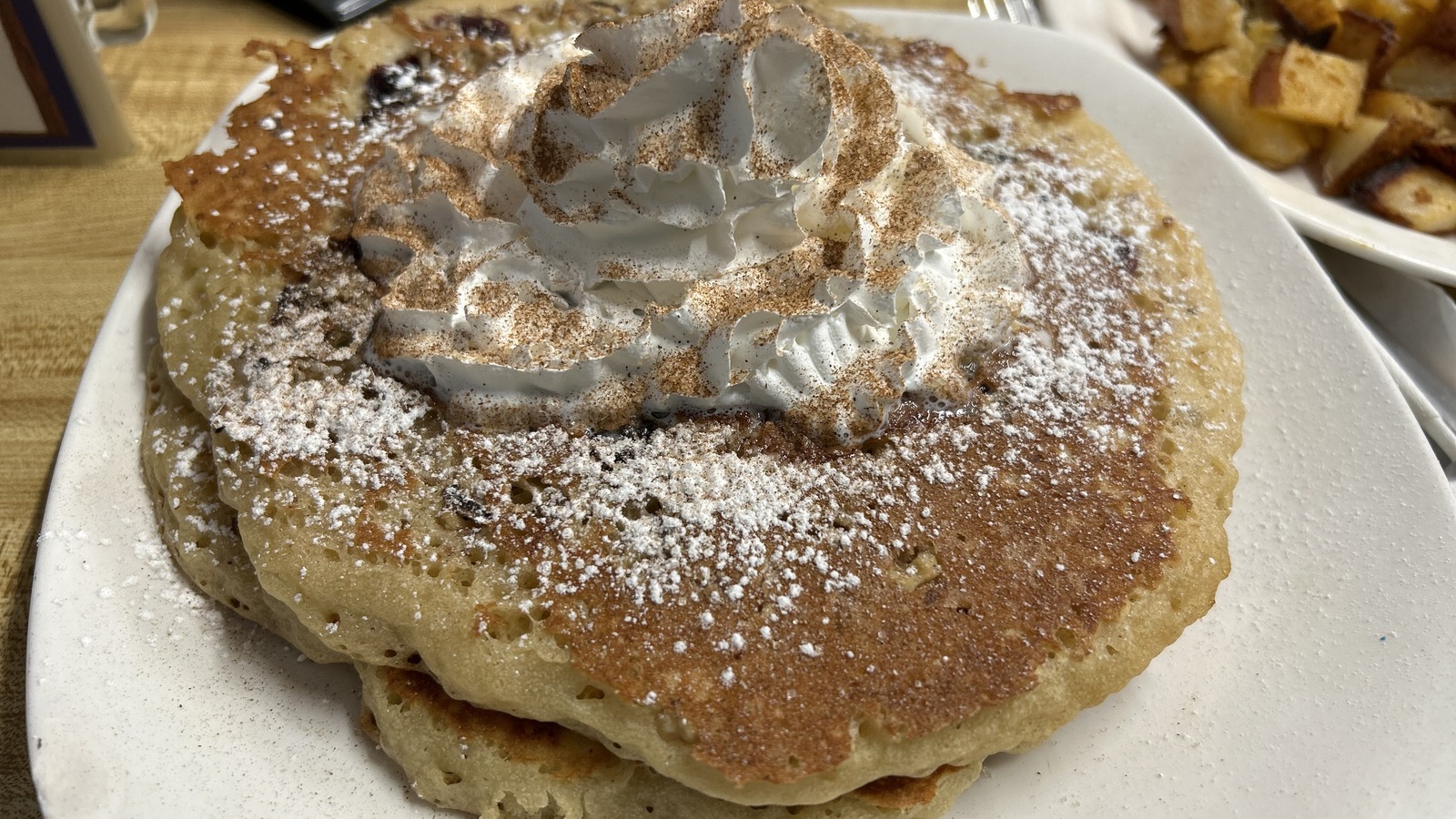 Powdered pancakes topped with whipped cream at Miss Worcester Diner
