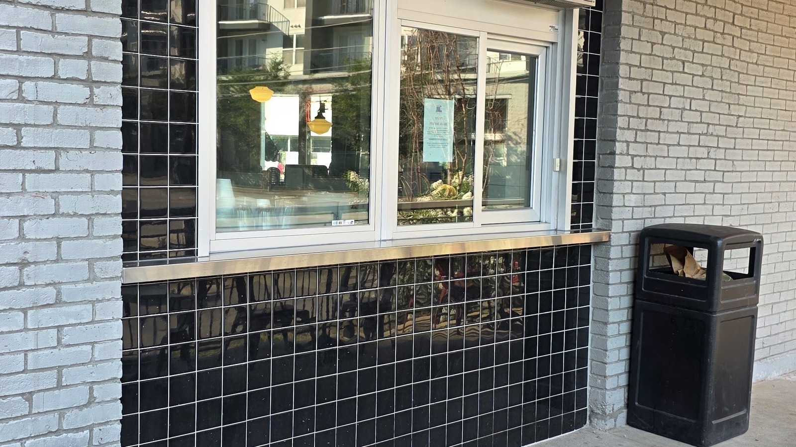 Sidewalk service window with black tile and Elliston Place Soda Shop lettering in Nashville