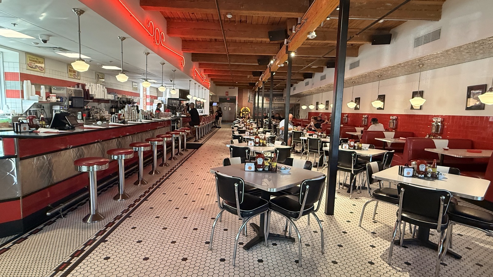 Long red counter, hex-tile floor, and booth-lined dining room inside Elliston Place Soda Shop