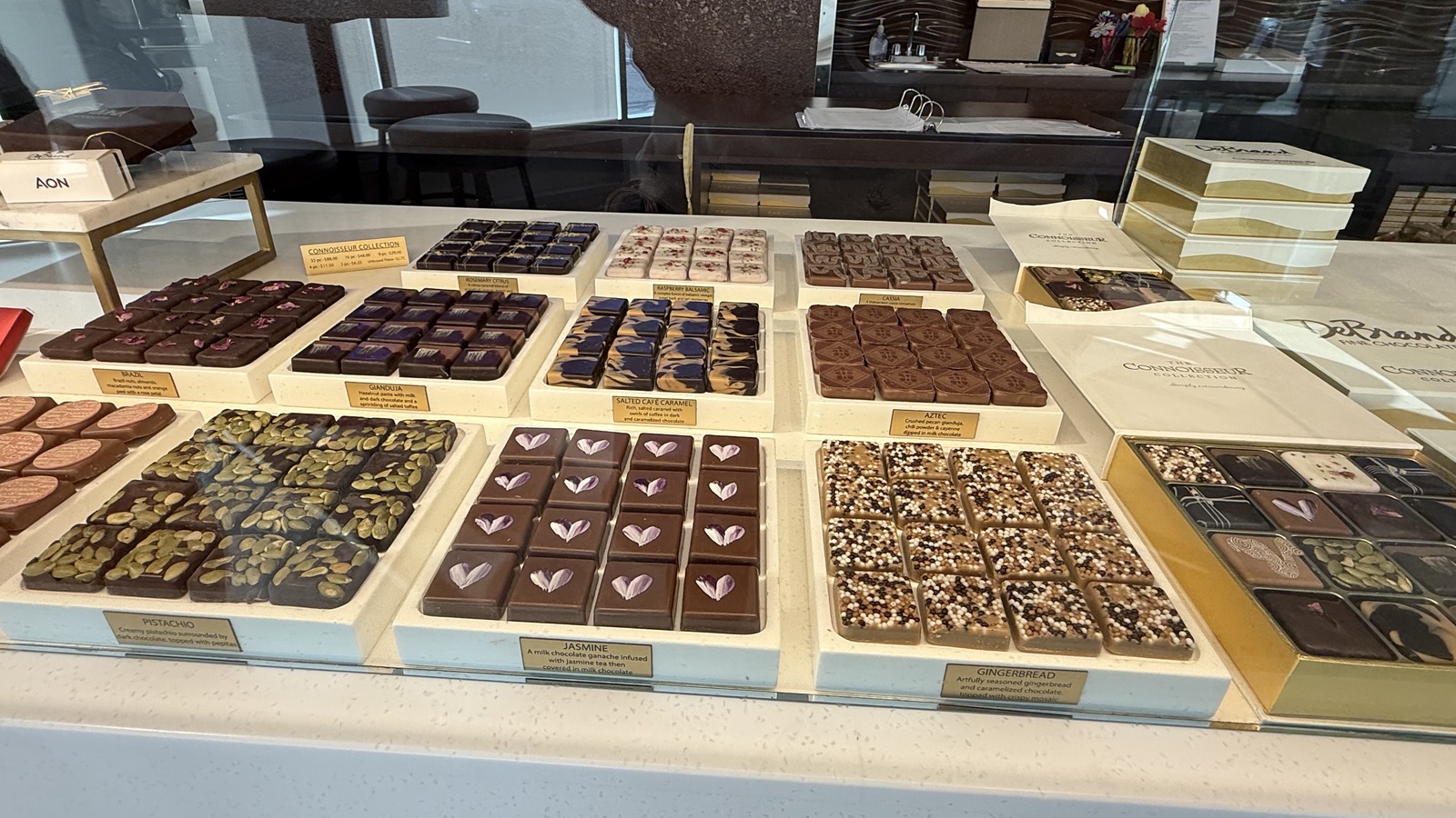 A glass case filled with boxed chocolates and truffles at DeBrand Fine Chocolates
