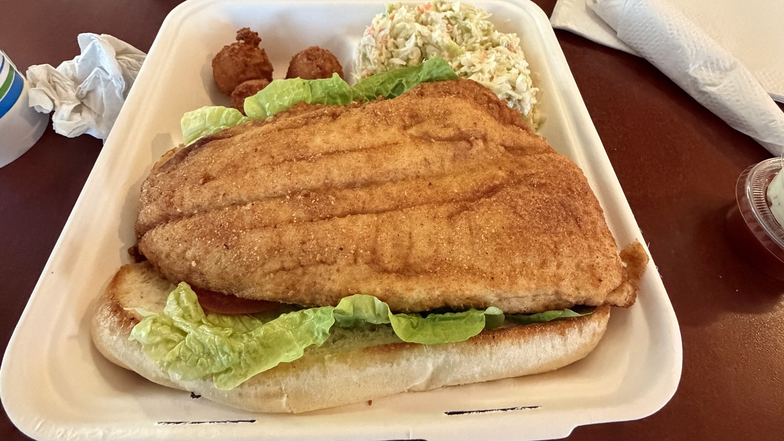 Large fried fish sandwich with coleslaw and hush puppies at The Great Machipongo Clam Shack