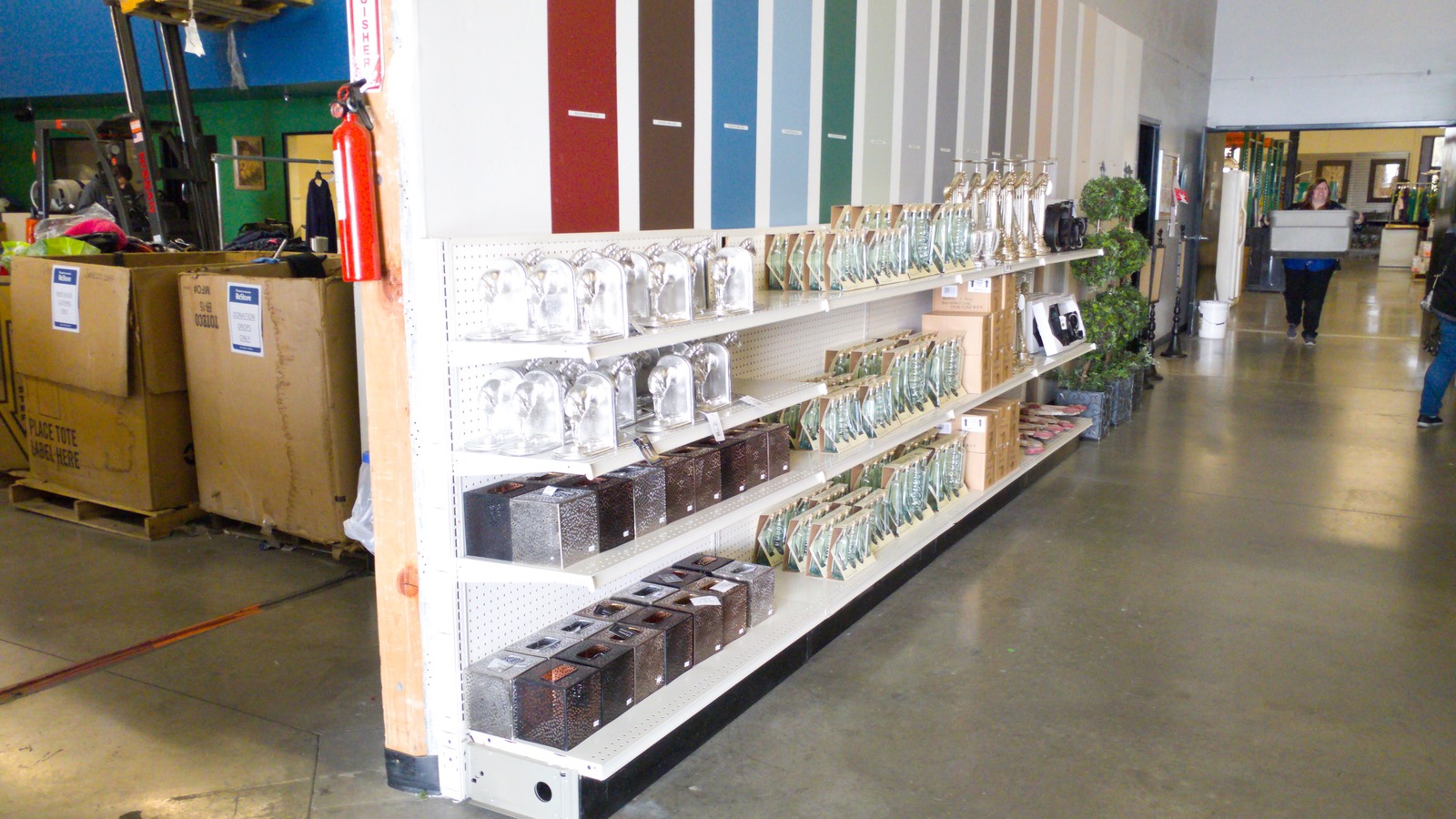 Paint samples, lighting, and home goods aisles inside Habitat For Humanity ReStore in Bakersfield