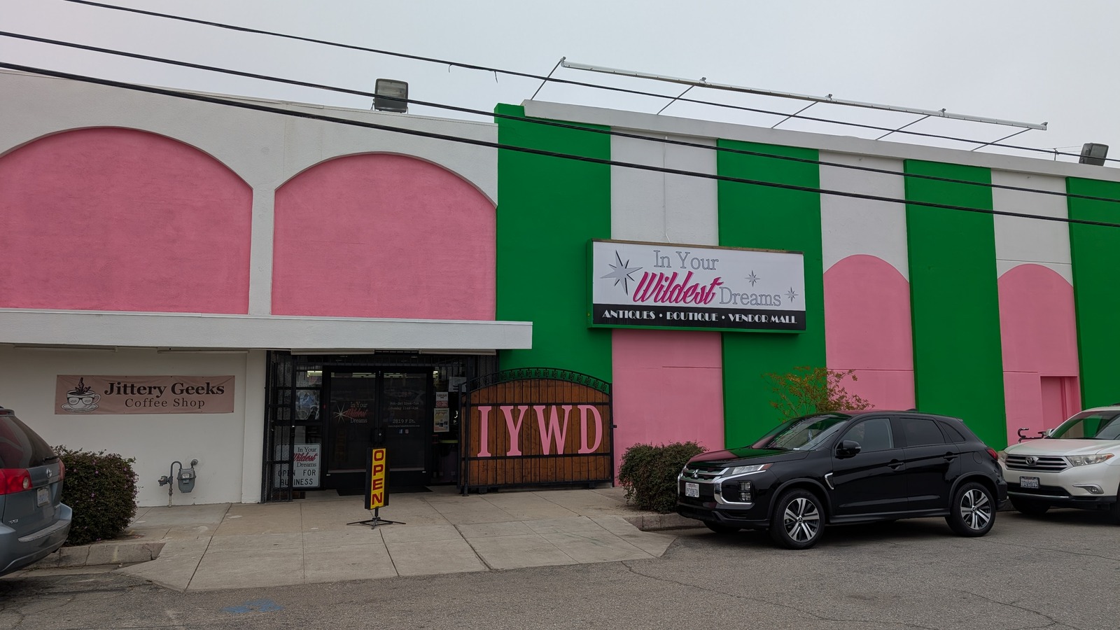 The bright pink and green storefront of In Your Wildest Dreams in downtown Bakersfield