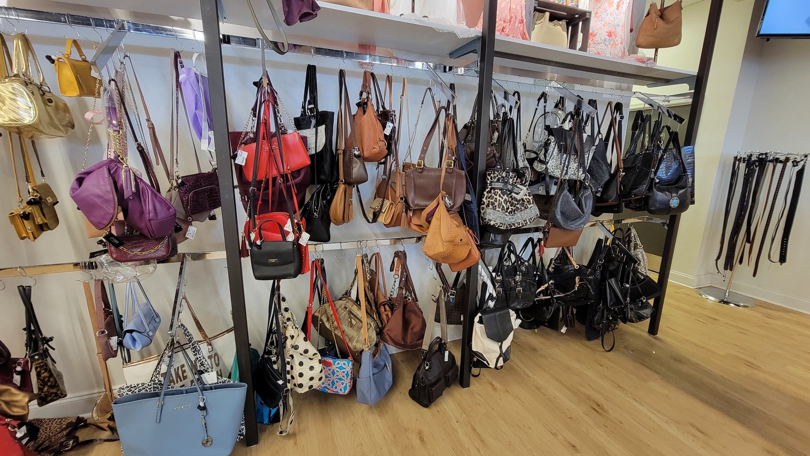 Handbag wall and accessory racks inside Uptown Cheapskate in Virginia Beach