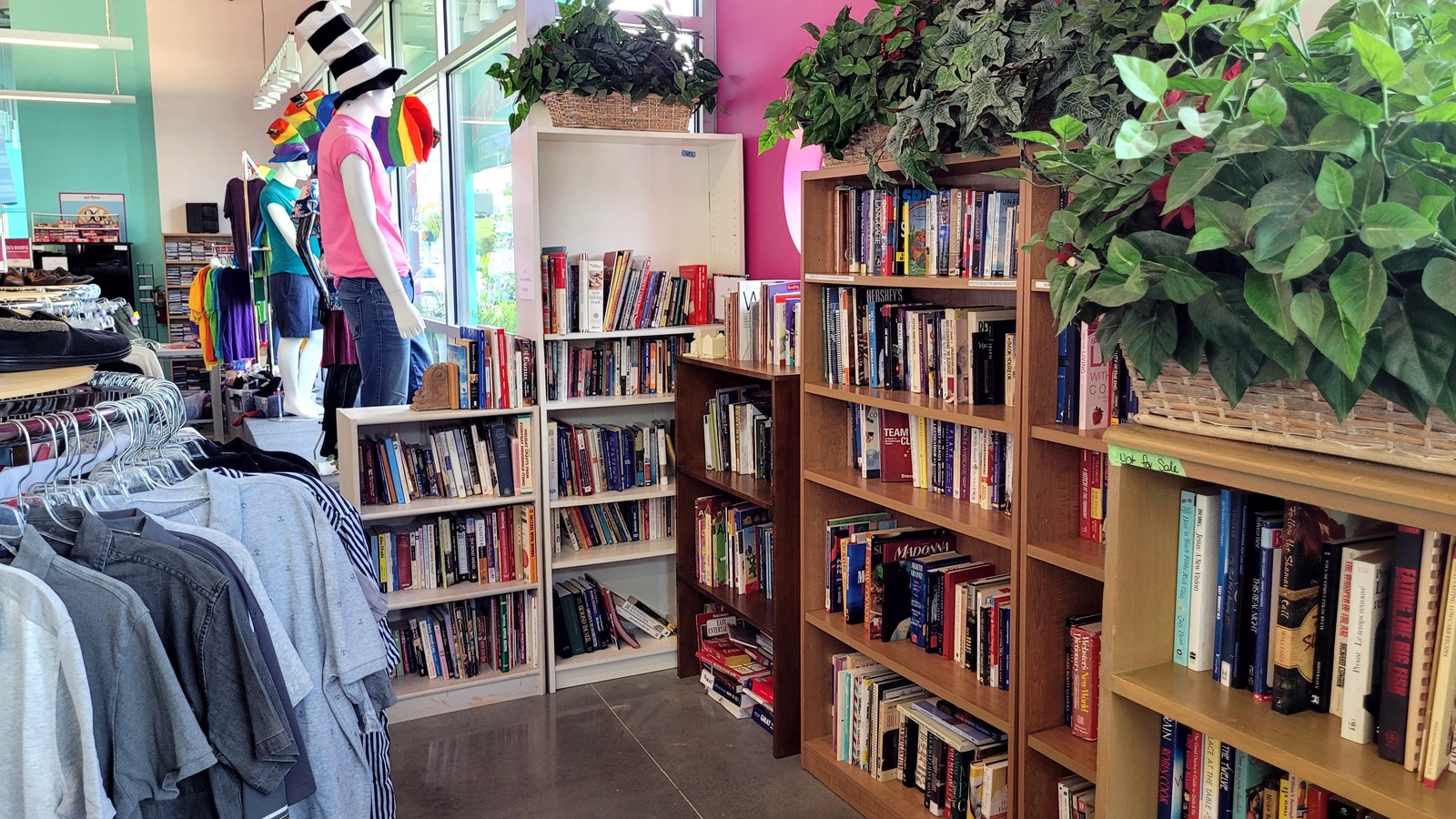 Bookshelves and clothing racks inside Out of the Closet in Orlando