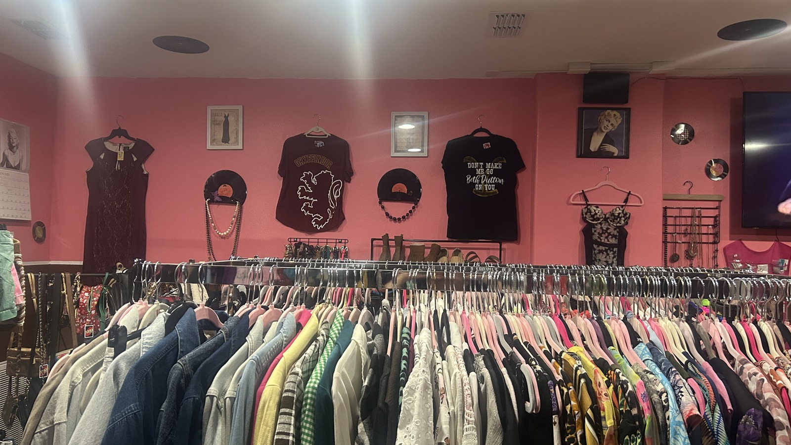 Pink clothing wall and accessory counter inside House Of 7 Vintage & Resale Shop in Harlingen