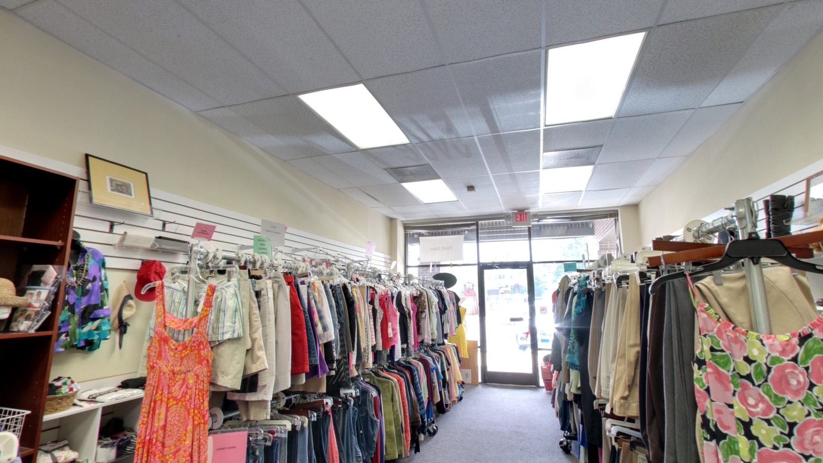 Bright clothing racks inside Cat Angels Thrift Store in Cary