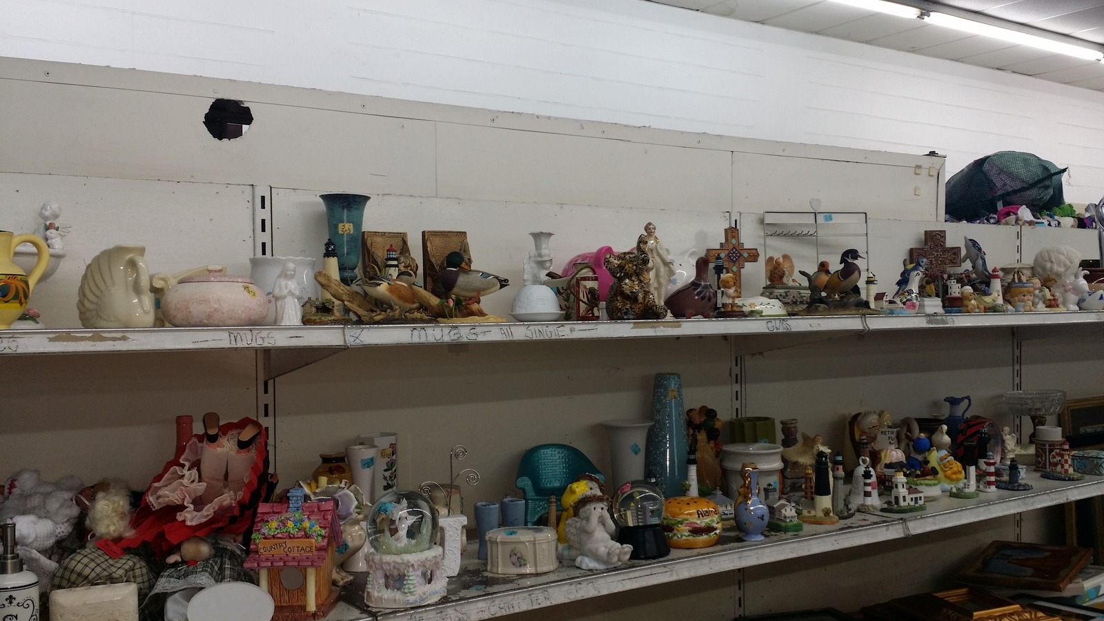 Collectibles and decor shelf inside Community Thrift Store