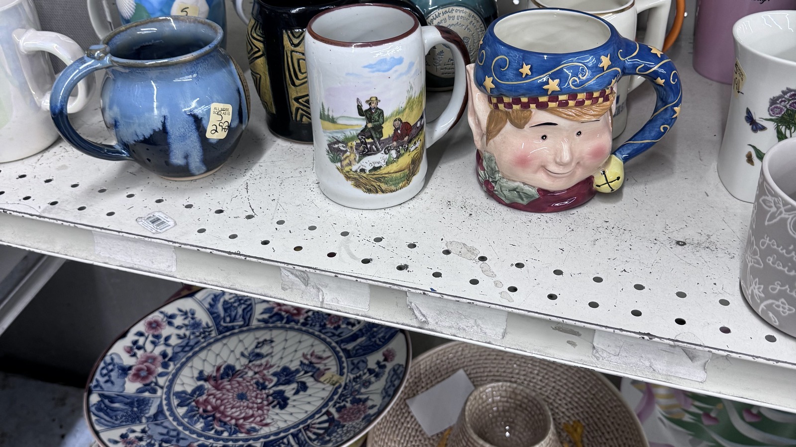 Decorative mugs and small dishware inside Community Thrift Store