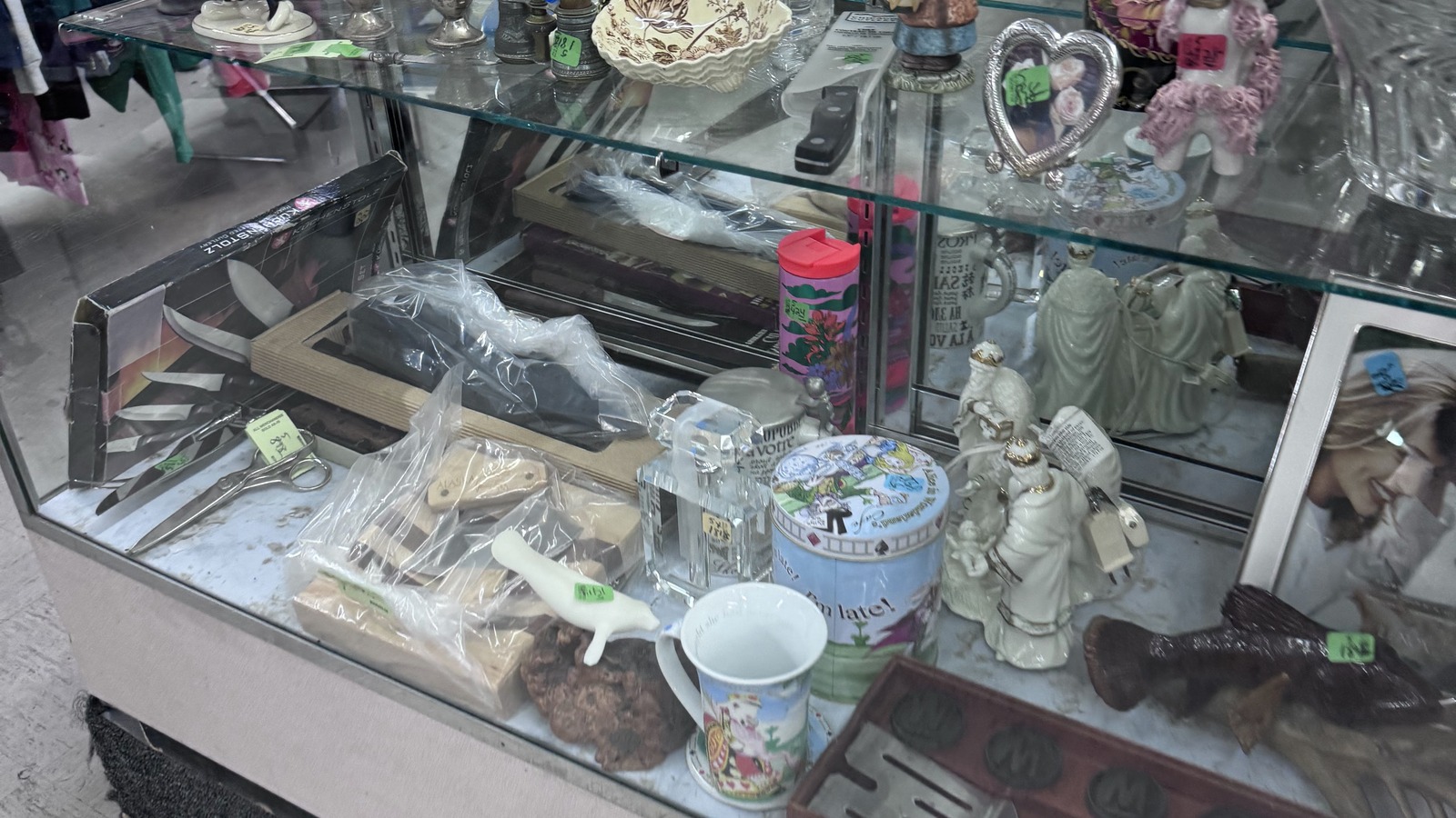 Glass case with small collectibles inside Community Thrift Store